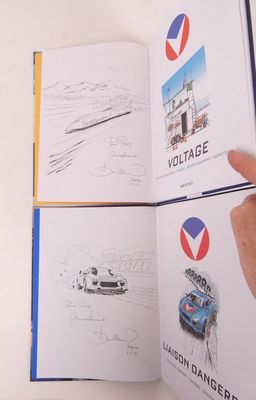 une personne tenant un livre sur lequel figurent des dessins de voitures