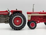 a red and white toy tractor and a red and white toy tractor