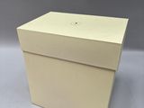 a white box with a lid that is open and sitting on a table