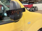 a close up of a yellow truck with a ruler on it ' s side mirror