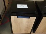 two black and wooden cabinets in a warehouse