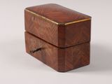 a small wooden box with a lid on a white surface