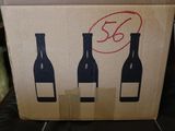 a cardboard box with three bottles of wine on it
