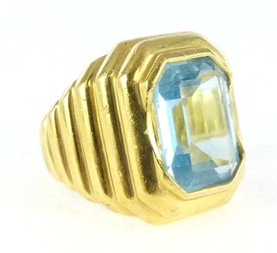 an image of a gold ring with a blue topaz stone