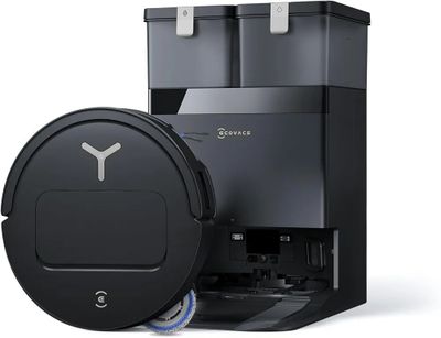 a close up of a black vacuum cleaner and a black trash can