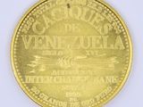 an image of a close up of a gold coin on a white surface