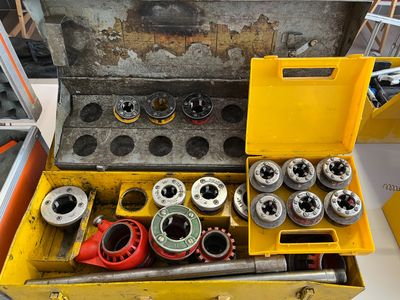 a yellow tool box filled with various tools on a table