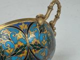 a blue and gold vase sitting on a white surface