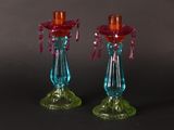 pair of colorful glass candlesticks on a black background