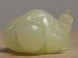a green jade sculpture of a turtle sitting on a table