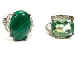 six different green and white rings with silver accents on a white background