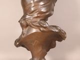 bronze bust of a woman with a scarf on her head