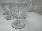 four empty wine glasses sitting on a table