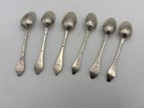 six silver spoons are lined up in a row on a white surface