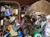 a basket full of key chains and other items in it
