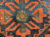 an image of a close up of a rug with an orange and blue design