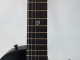 a close up of a black guitar with a white background