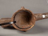 a wooden pipe with a black handle on a gray surface