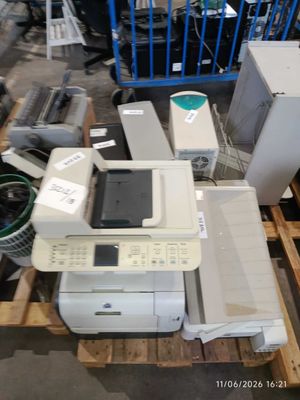a pile of electronic equipment on a pallet in a warehouse
