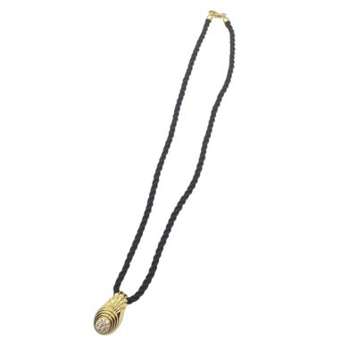 a black and gold necklace with a shell pendant on it