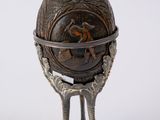 a metal object with a bird ' s feet and a ball on it