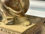 a statue of a dog sitting on top of a box