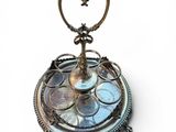 a silver plate with a heart shaped candle holder on it