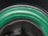 a close up view of a green and black container