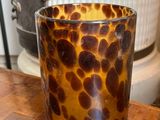 leopard print glass cup on a wooden table in a kitchen
