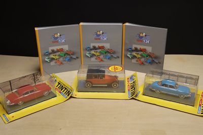 three boxed toy cars are sitting on a table in front of a black background
