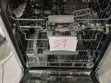 a dishwasher that has a lot of dishes inside of it