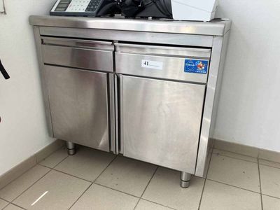 a stainless steel counter with a microwave on top