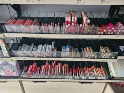 a lot of lipsticks on the shelves in the store