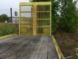 a yellow gate that is on the side of the road