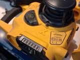 a close up of a corded sander on a table