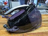a black and silver steam iron sitting on a wooden table