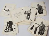 several old postcards of men are sitting on top of a table
