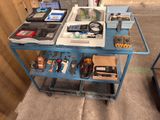 a blue cart with electronics on it in a room