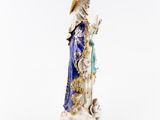 a figurine of a woman with a parasol and a dog