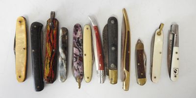 several different types of knives are lined up on a white surface