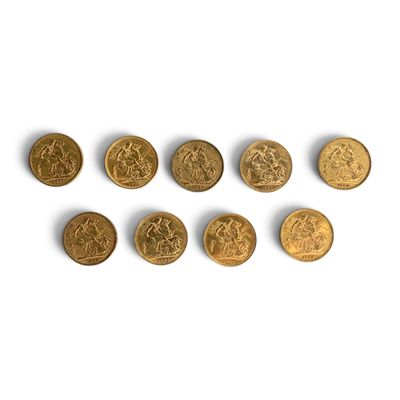 several gold coins are arranged in a row on a white surface