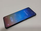 the back of a black samsung s9 phone sitting on a white table