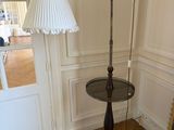 a lamp that is on a table in the corner of a room