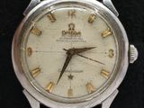 a silver watch with roman numerals on the face