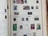 an open book with stamps on it on a table