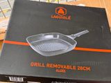 the box of a grill removeable pan is sitting on the table