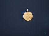 a gold coin is shown on a black surface