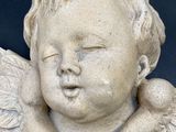 a statue of an angel with wings on it ' s head