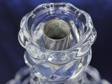 a glass candle holder with a candle inside of it