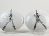 two white balls with silver ribbons tied to them